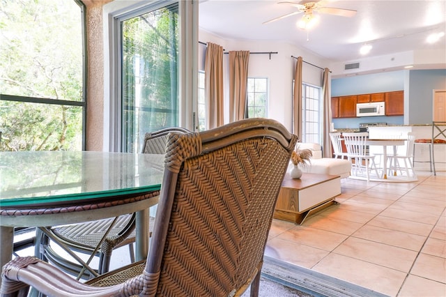 tiled dining room featuring ceiling fan