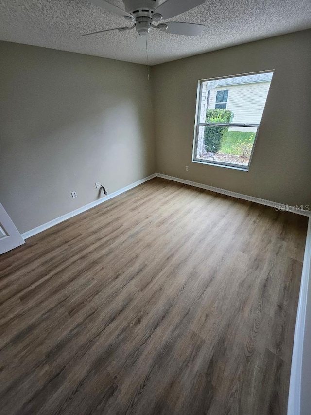 unfurnished room with hardwood / wood-style flooring, ceiling fan, and a textured ceiling