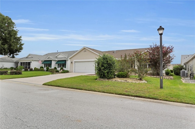 single story home featuring central AC unit, a garage, and a front yard