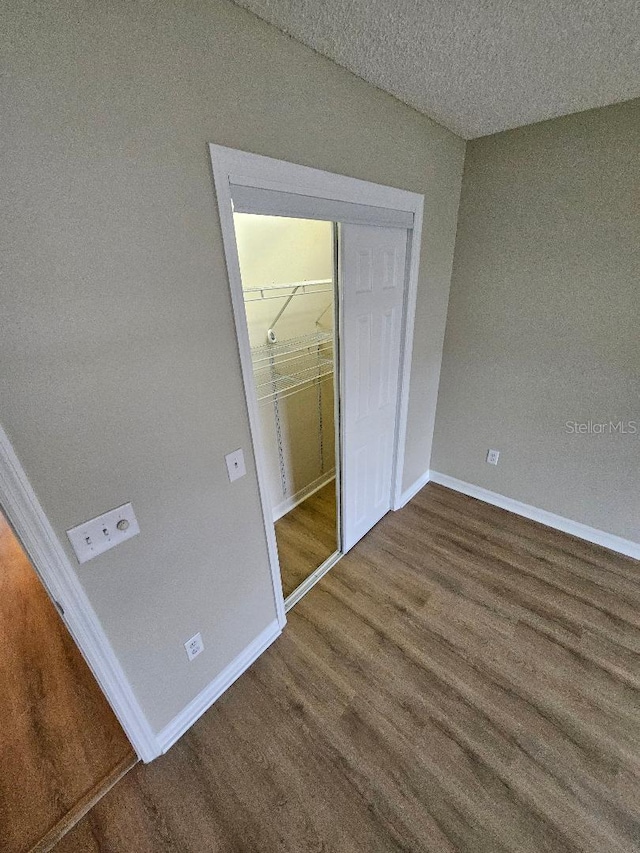 unfurnished bedroom featuring hardwood / wood-style floors and a closet