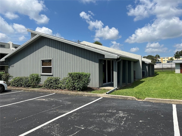 view of parking featuring a lawn