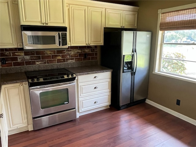 kitchen featuring stainless steel appliances, tasteful backsplash, and dark hardwood / wood-style flooring