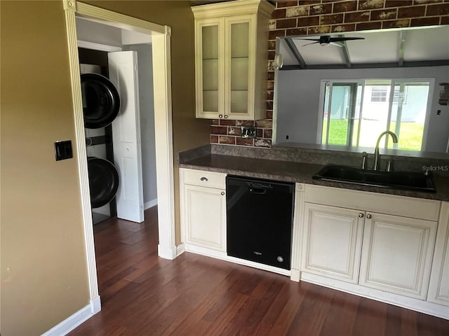 kitchen featuring sink, dishwasher, white cabinetry, and stacked washing maching and dryer