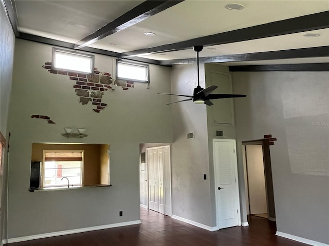 interior space with dark wood-type flooring, beam ceiling, a healthy amount of sunlight, and ceiling fan