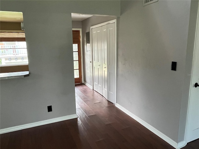 hallway with dark hardwood / wood-style flooring