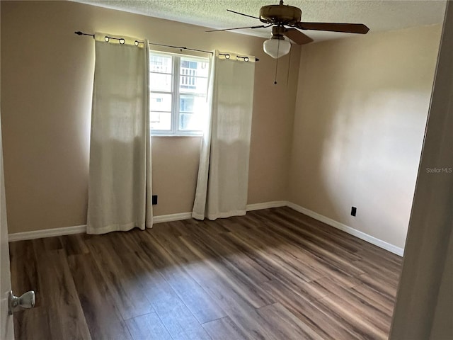 unfurnished room with dark wood-type flooring, a textured ceiling, and ceiling fan