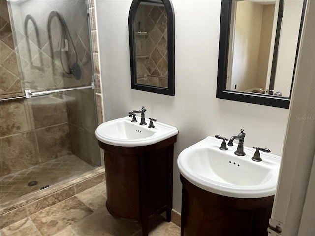 bathroom with vanity and tiled shower