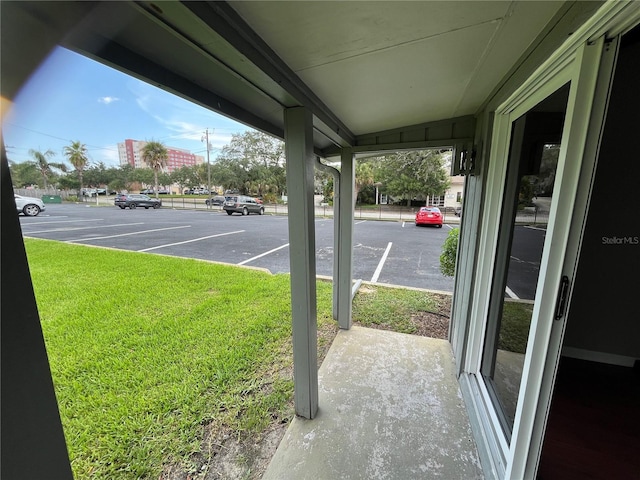 view of parking with a lawn