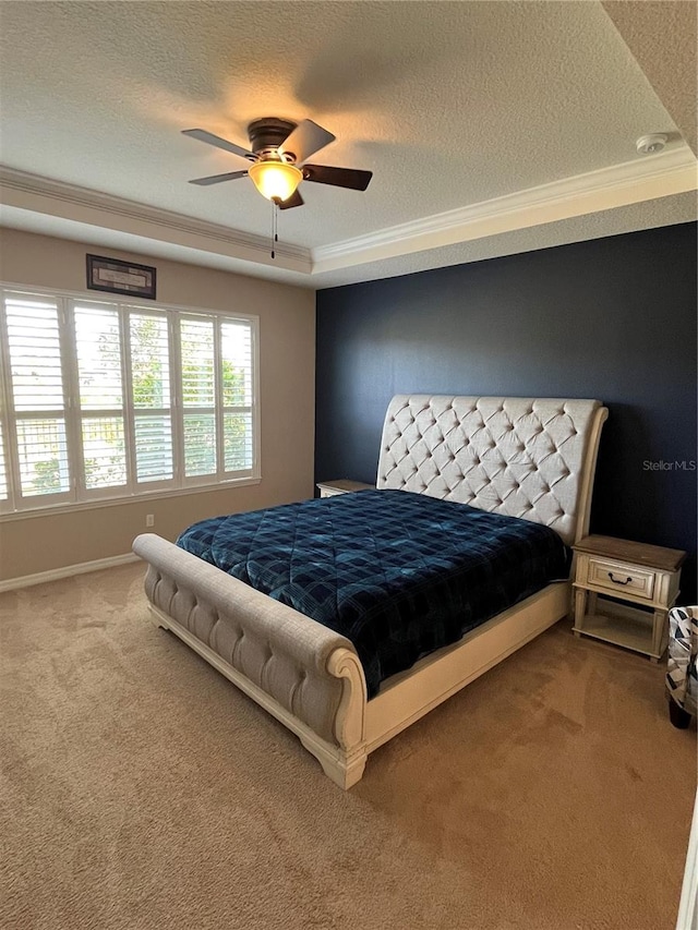 bedroom featuring carpet, ceiling fan, crown molding, and a textured ceiling