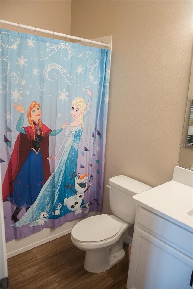 bathroom with vanity, hardwood / wood-style floors, and toilet