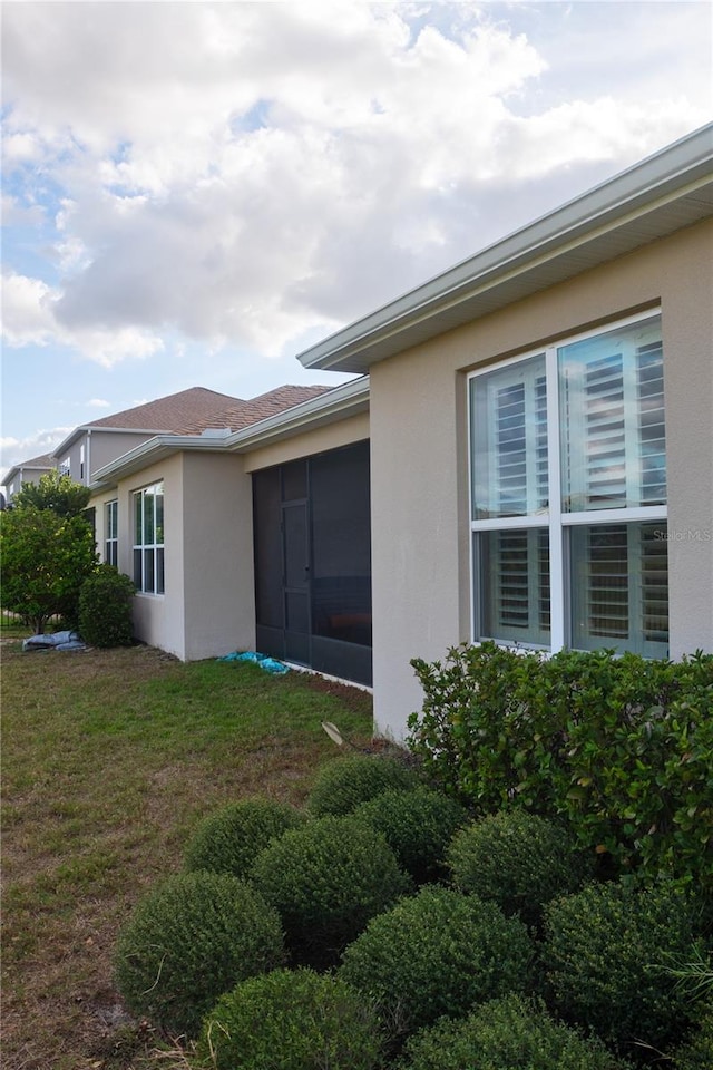 view of side of property with a yard