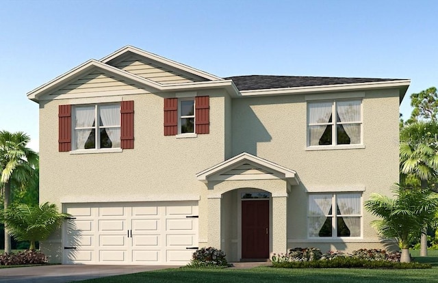 view of front of home featuring a front yard and a garage