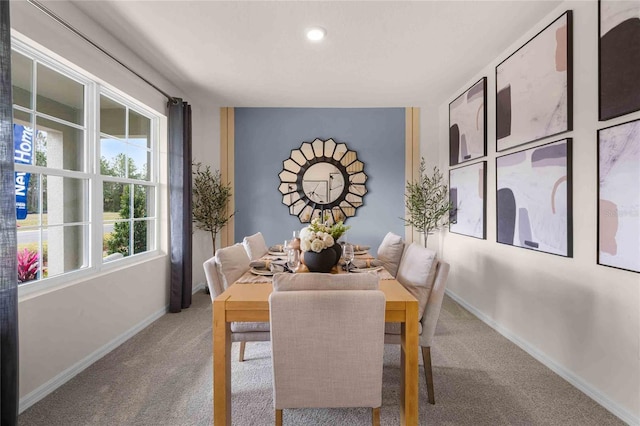 carpeted dining room featuring a healthy amount of sunlight