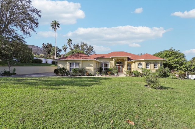 mediterranean / spanish-style house featuring a front yard