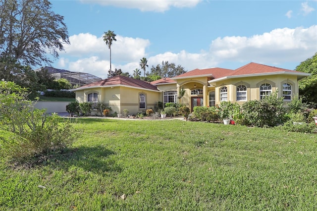 mediterranean / spanish house featuring a front lawn