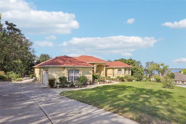 mediterranean / spanish-style home featuring a front yard