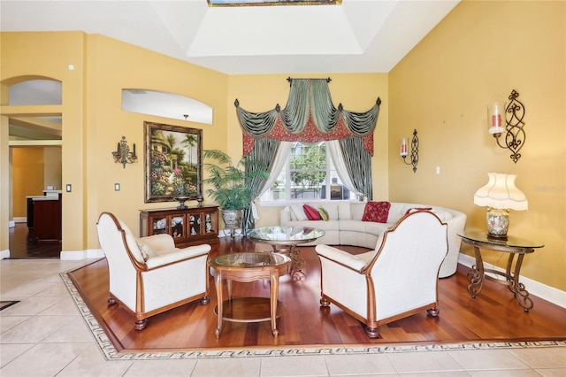 tiled living room with a skylight