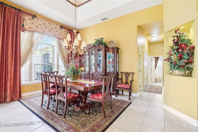 tiled dining space with a notable chandelier