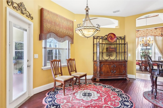 living area with a notable chandelier and dark hardwood / wood-style floors