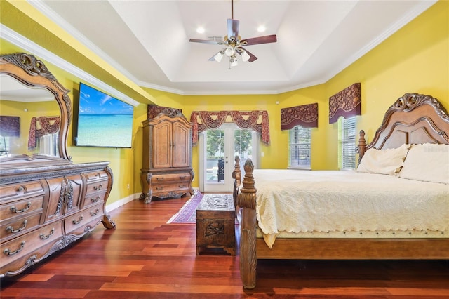 bedroom featuring a tray ceiling, dark hardwood / wood-style flooring, access to exterior, ceiling fan, and ornamental molding