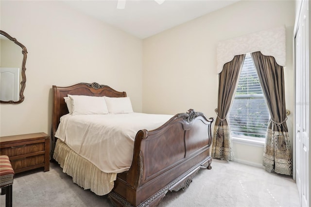 bedroom with ceiling fan and light carpet