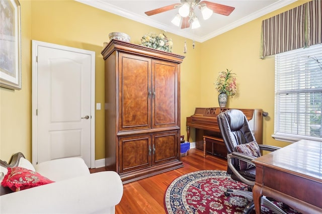 office area with dark wood-type flooring, crown molding, and ceiling fan