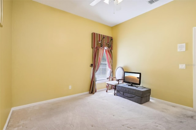 living area featuring ceiling fan and light colored carpet