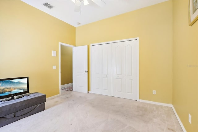 bedroom with light carpet, a closet, and ceiling fan