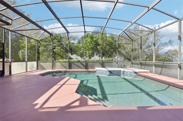 view of pool featuring a patio, a hot tub, and a lanai