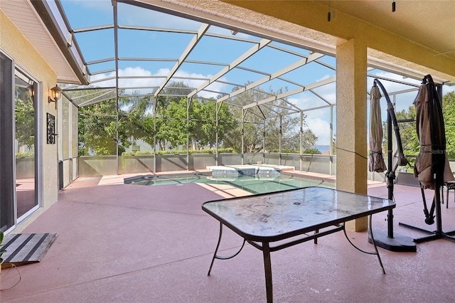 view of patio / terrace with a lanai and a pool with hot tub