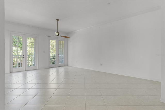 spare room featuring crown molding, french doors, light tile patterned flooring, and ceiling fan