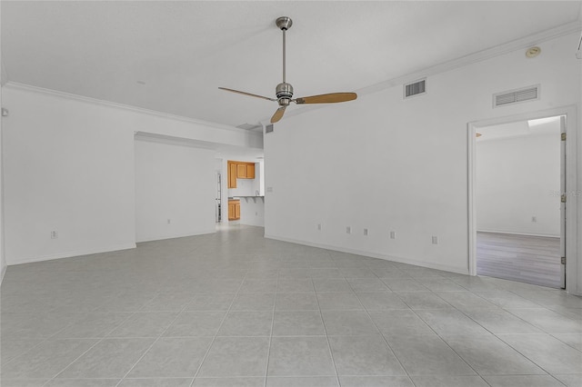 empty room with crown molding, ceiling fan, and light tile patterned floors