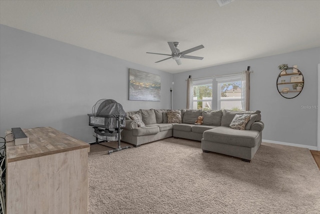 carpeted living room with ceiling fan