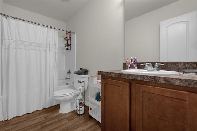 full bathroom featuring vanity, hardwood / wood-style floors, shower / tub combo with curtain, and toilet