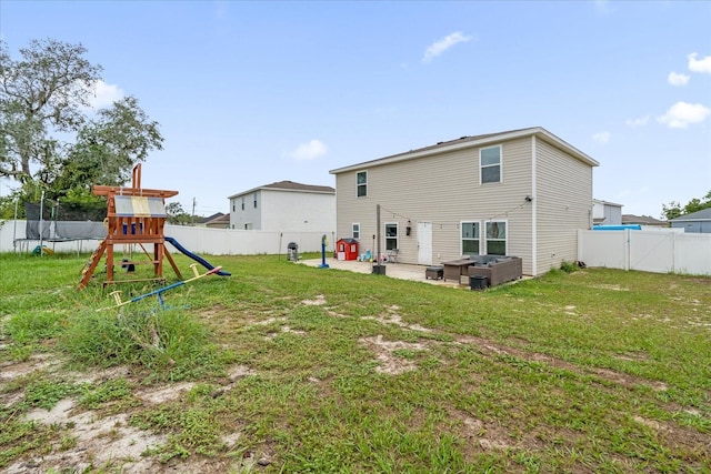 rear view of house with a patio, a playground, and a lawn