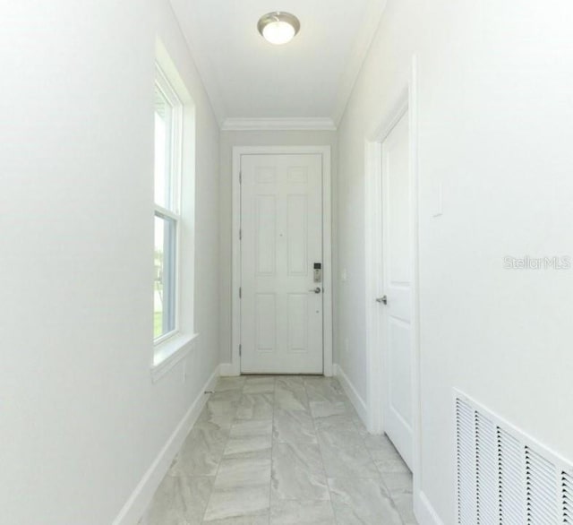 doorway featuring ornamental molding