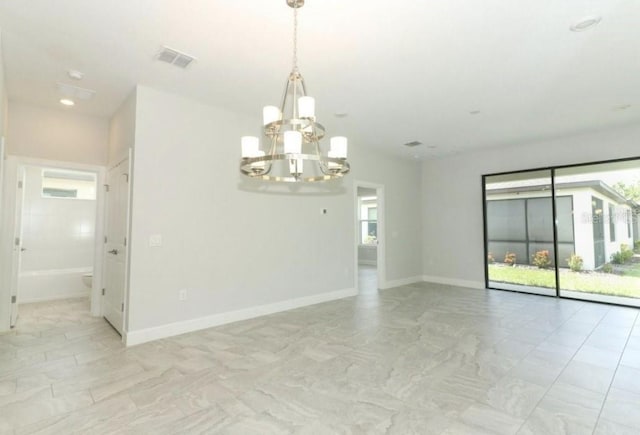 unfurnished room featuring an inviting chandelier and plenty of natural light