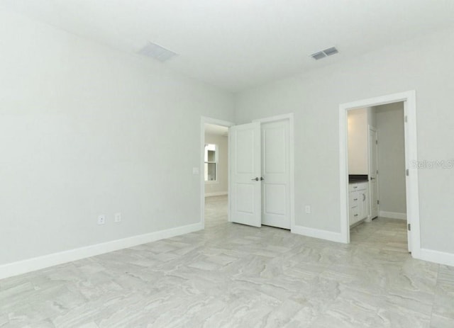 unfurnished bedroom featuring ensuite bath