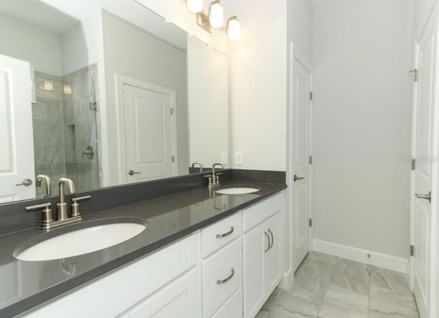 bathroom with a shower with door and vanity