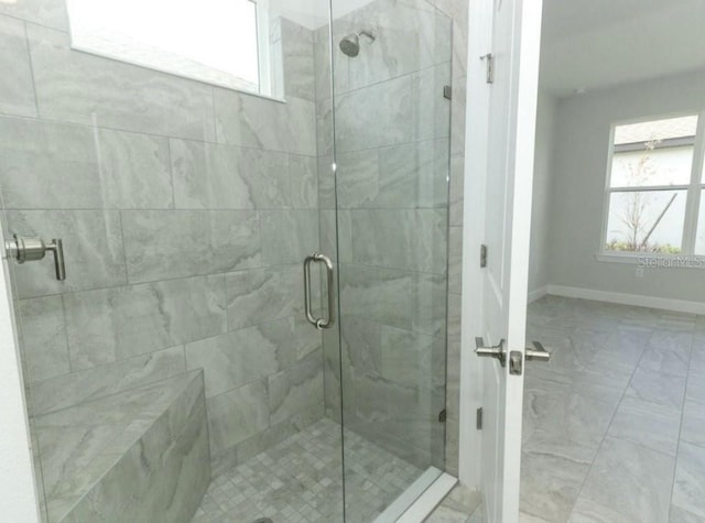 bathroom with a shower with shower door