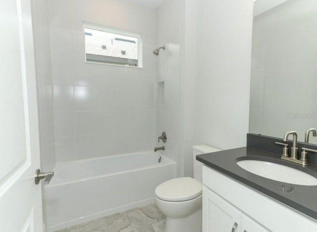 full bathroom with vanity, tiled shower / bath combo, and toilet