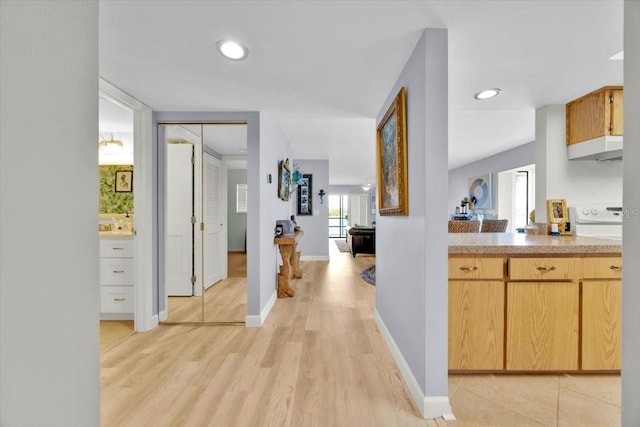 corridor with light hardwood / wood-style floors