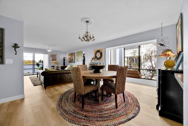 dining area featuring light hardwood / wood-style floors, a chandelier, and plenty of natural light