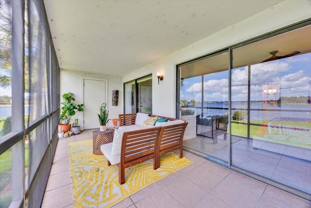 sunroom / solarium featuring a water view