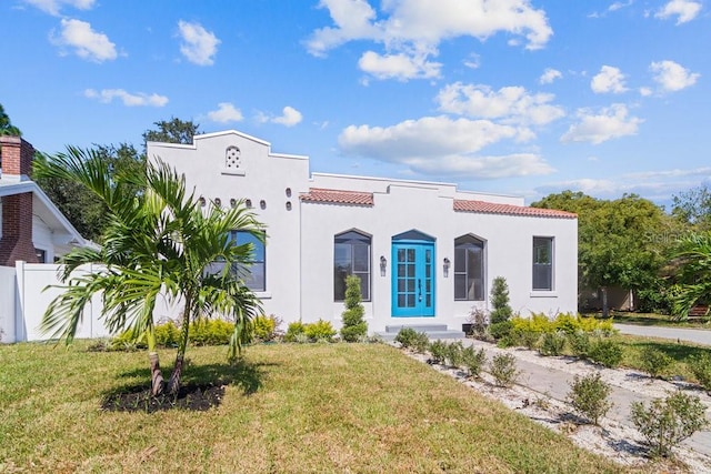 mediterranean / spanish house with a front lawn