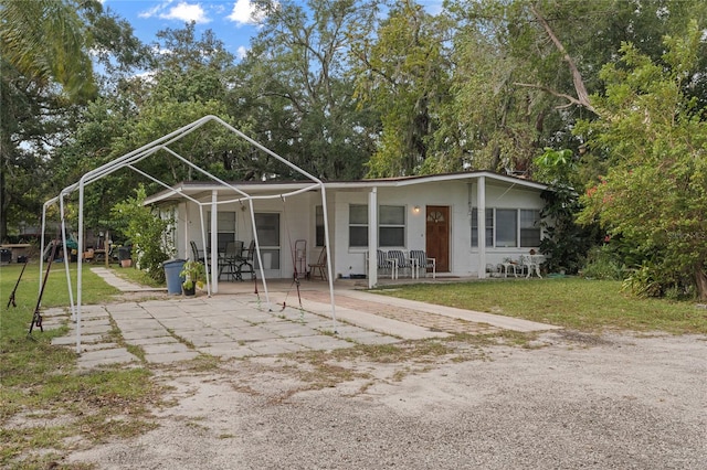 view of front of property featuring a patio and a front yard