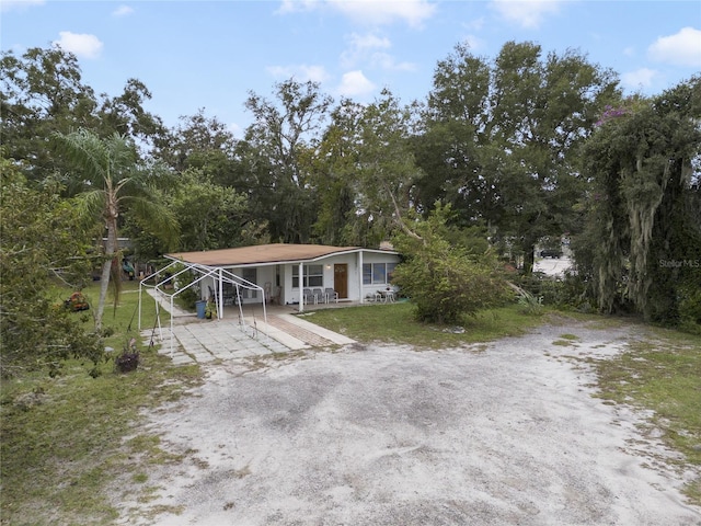 view of front of property featuring covered porch and a carport