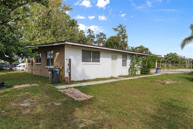 view of side of home featuring a yard