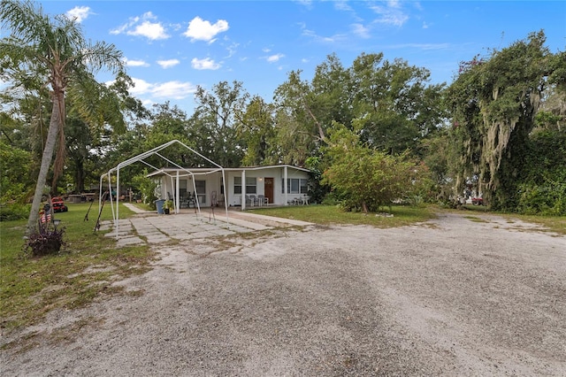 exterior space with covered porch and a front yard