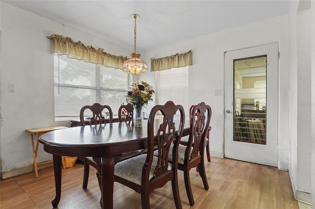 dining area with a chandelier and light wood-type flooring